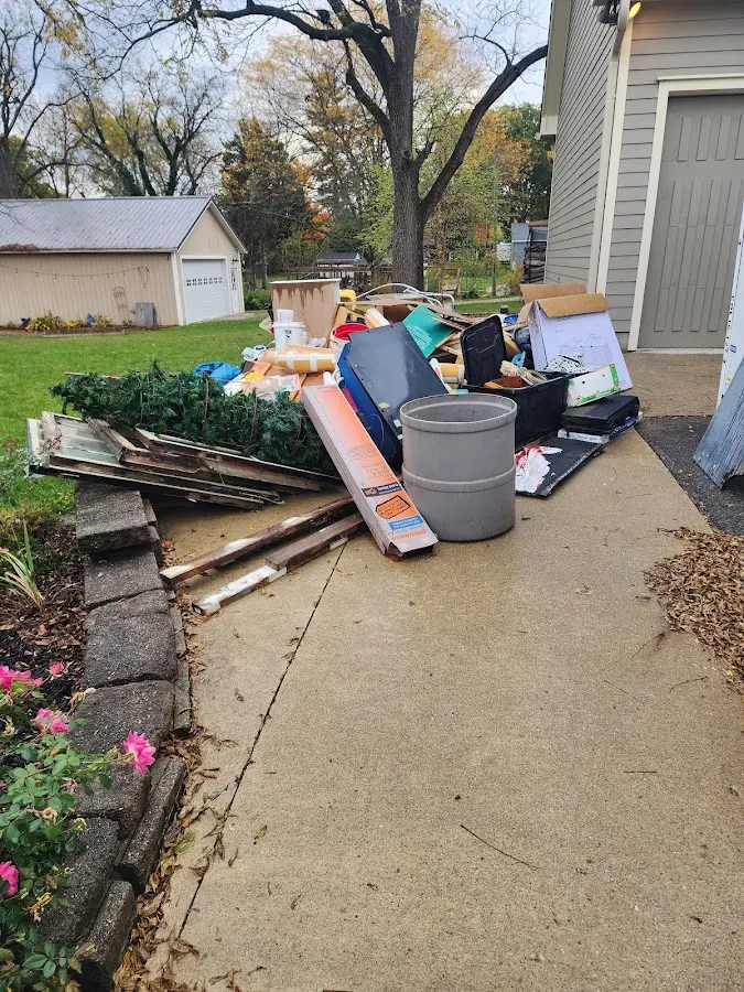 Dumpster being loaded with debris for Estate Cleanout Dumpster Rental in Murray